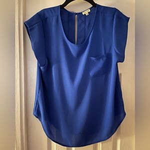 Royal blue short sleeve blouse with front pocket and back button